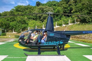 Tourists riding a helicopter to explore Boracay Island