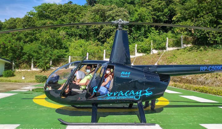 Tourists riding a helicopter to explore Boracay Island