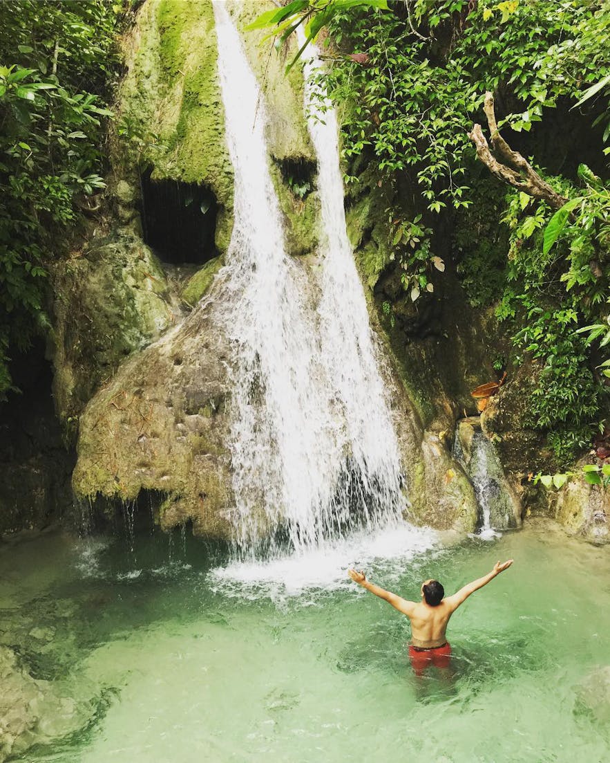 Man swimming in the Kalubihon Falls