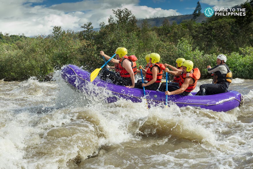 Tourists white water rafting in a river