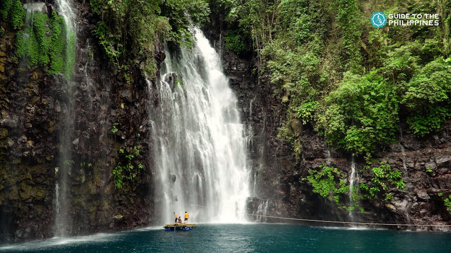 People floating on raft by the Tinago Falls