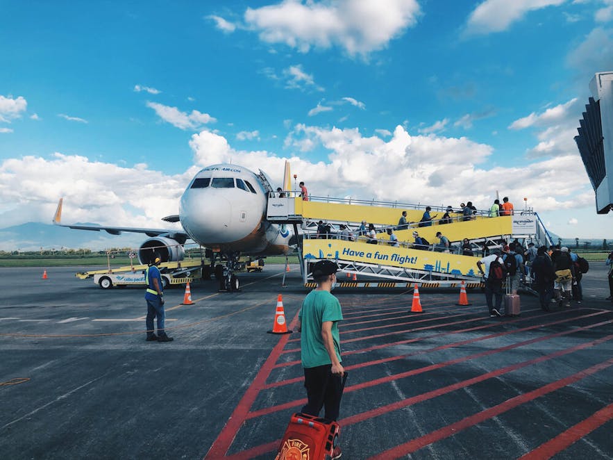 Passengers board a plane at the Ioilo International Airport