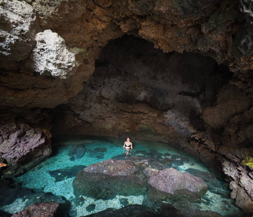Tourist wades in the Combento Cave Pool