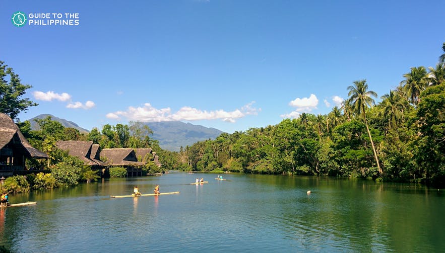 People rafting on a river in Villa Escudero