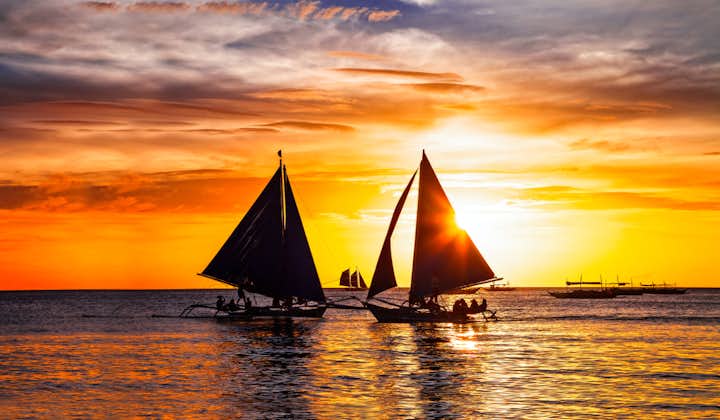 Silhouette of Paraw Sailing Boats at Sunset in Boracay Island