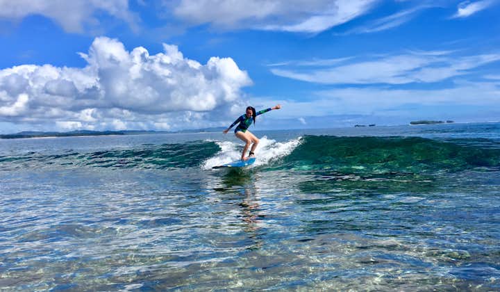 Tourist enjoying Surfing Activities during a Siargao Island Hopping Shared Tour in Surigao del Norte