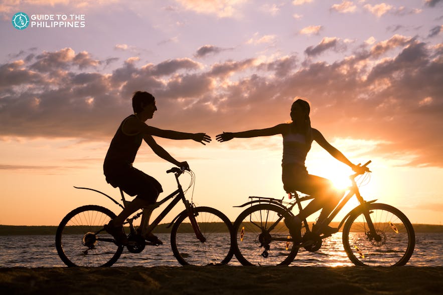 Couple biking at sunset