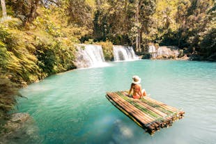 A Tourist sitting on a Raft at Kawasan Falls in Badian in Cebu