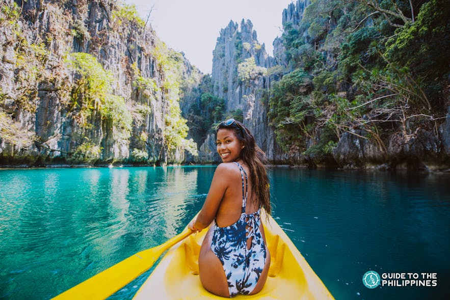 Woman kayaking in a Coron lagoon