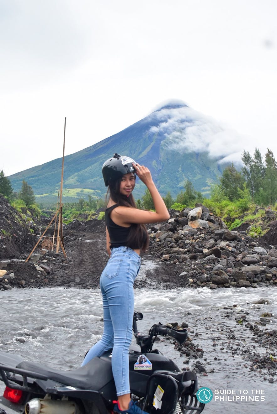 Woman posing in front of Mayon Volcano