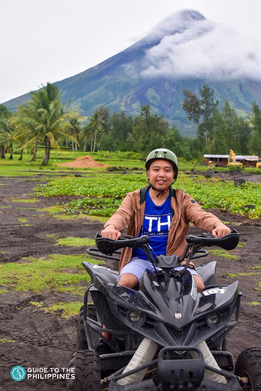 Man riding an ATV by Mayon Volano