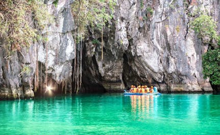 A boat with tourists going  inside Puerto Princesa Underground River
