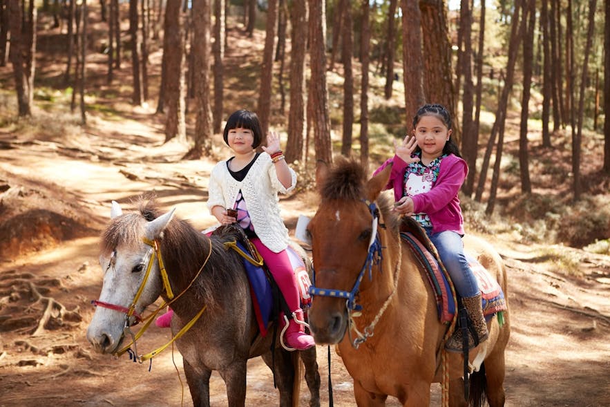 Children riding horses in Baguio
