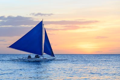 Paraw sailing during sunset in Boracay Island, Philippines