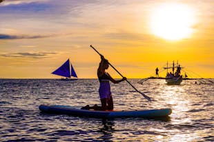 Paddle board while your friend enjoy the sunset cruise in Boracay