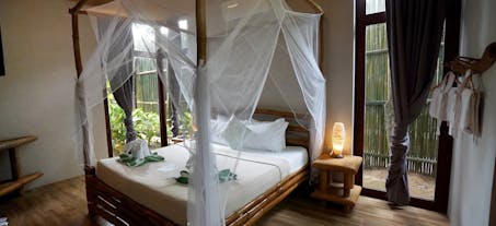 Enjoy your comfy bed at your standard cottage room of Buko Beach Resort El Nido Palawan