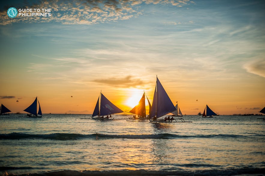 Paraws sailing during sunset in Boracay