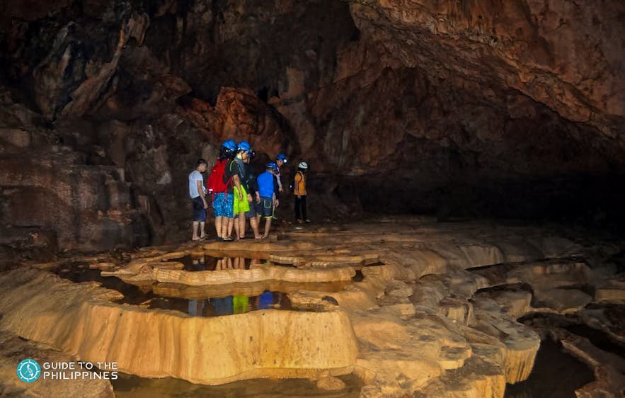 Tourists explore Bagumbungan Cave
