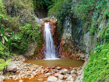 Pulangbato Falls in Dumaguete which is known for the red rocks in its catch basin.