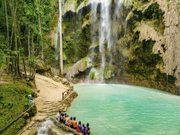 Experience the cold turquoise waters of Tumalog Falls