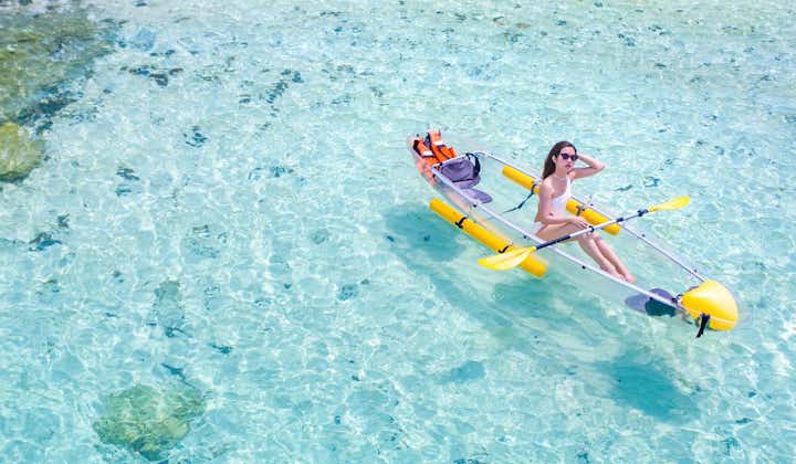 Woman riding a crystal kayak in Boracay