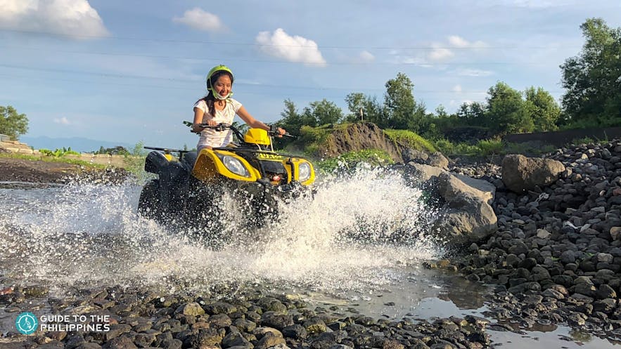 Woman trying ATV ride on a river
