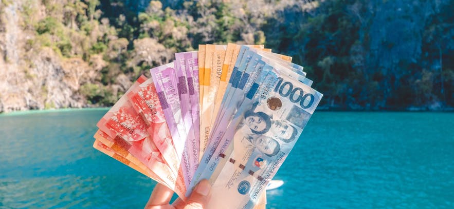 Philippine money in front of an island