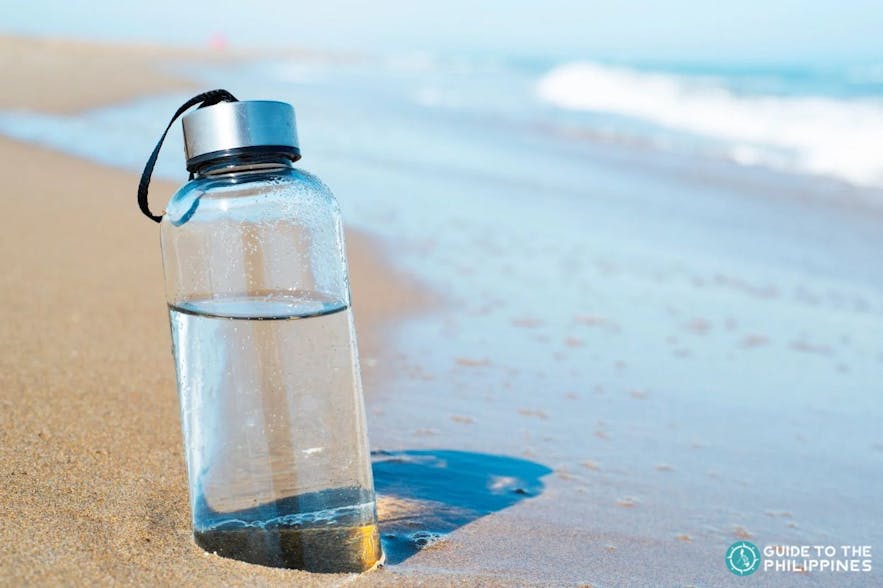 Reusable water bottle in a beach