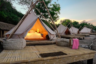 Wake up inside your glamping tent and hear the sounds of nature